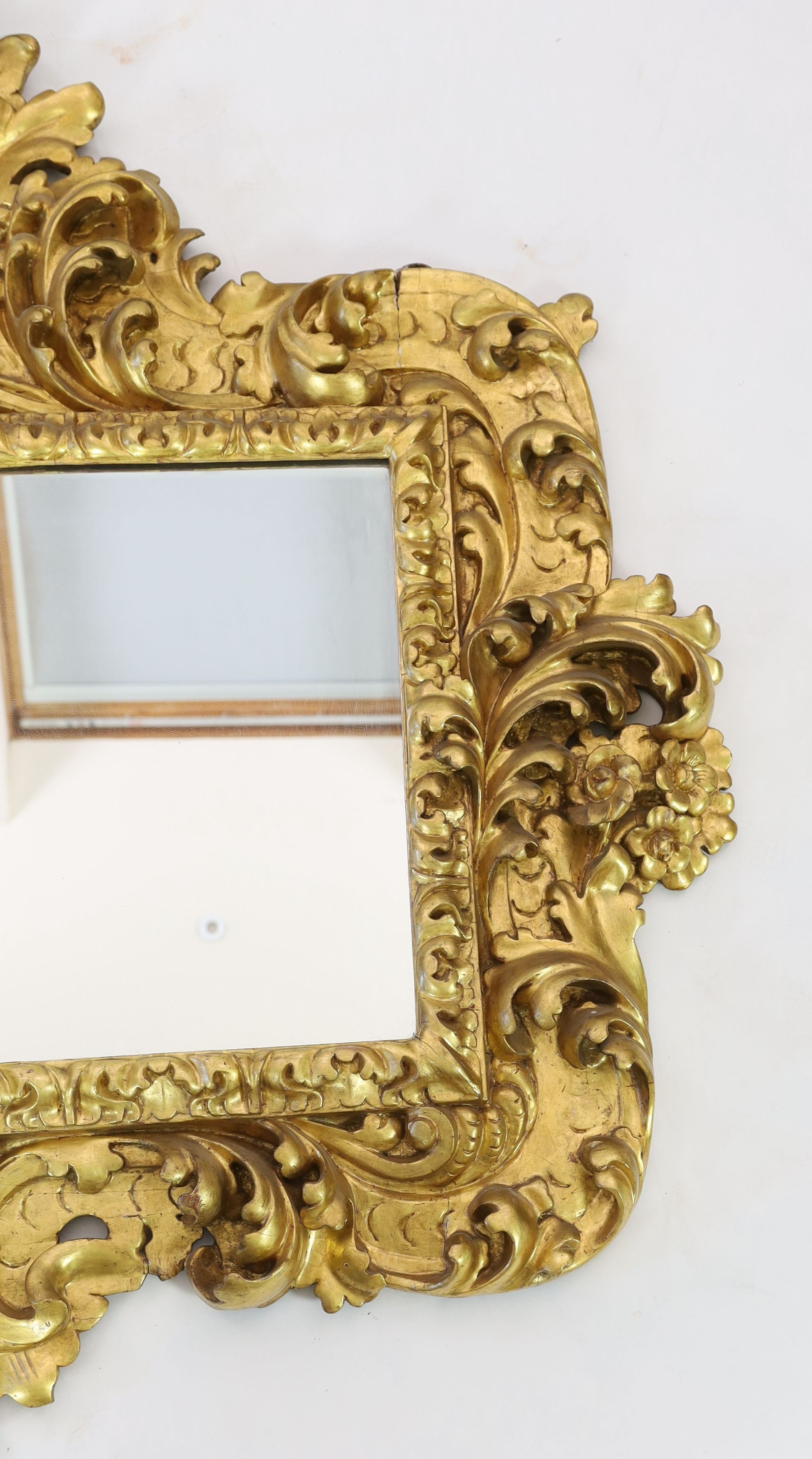 A mid 19th century Florentine ornately carved giltwood wall mirror, W.166cm H.158cm